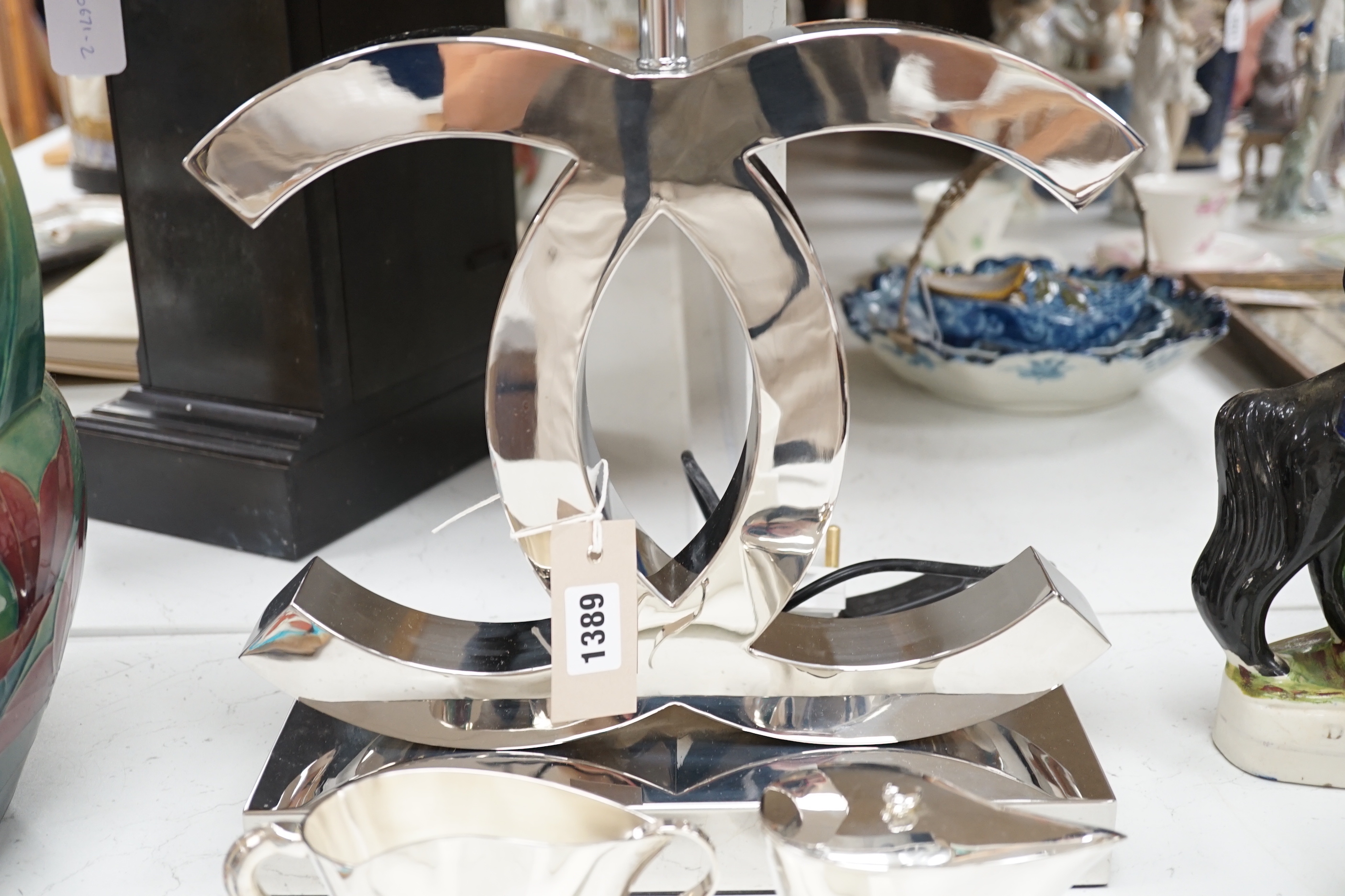 A contemporary chrome table lamp and Modernist tea ware including two Alessi cups and saucers, the lamp 59cm high overall